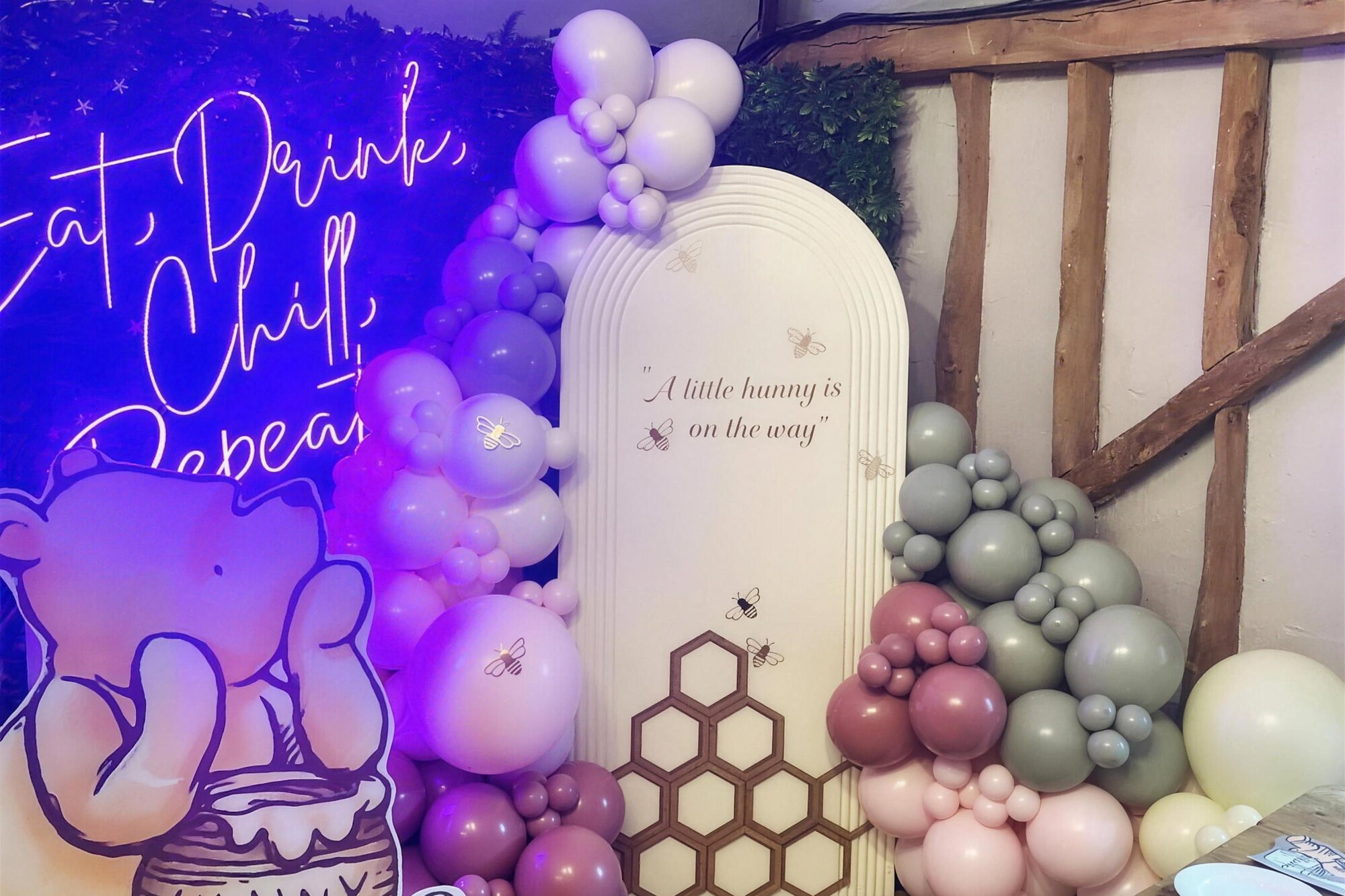 A baby shower beautifully styled and decorated at The BarnYard, with balloon arch and honeycomb backdrop