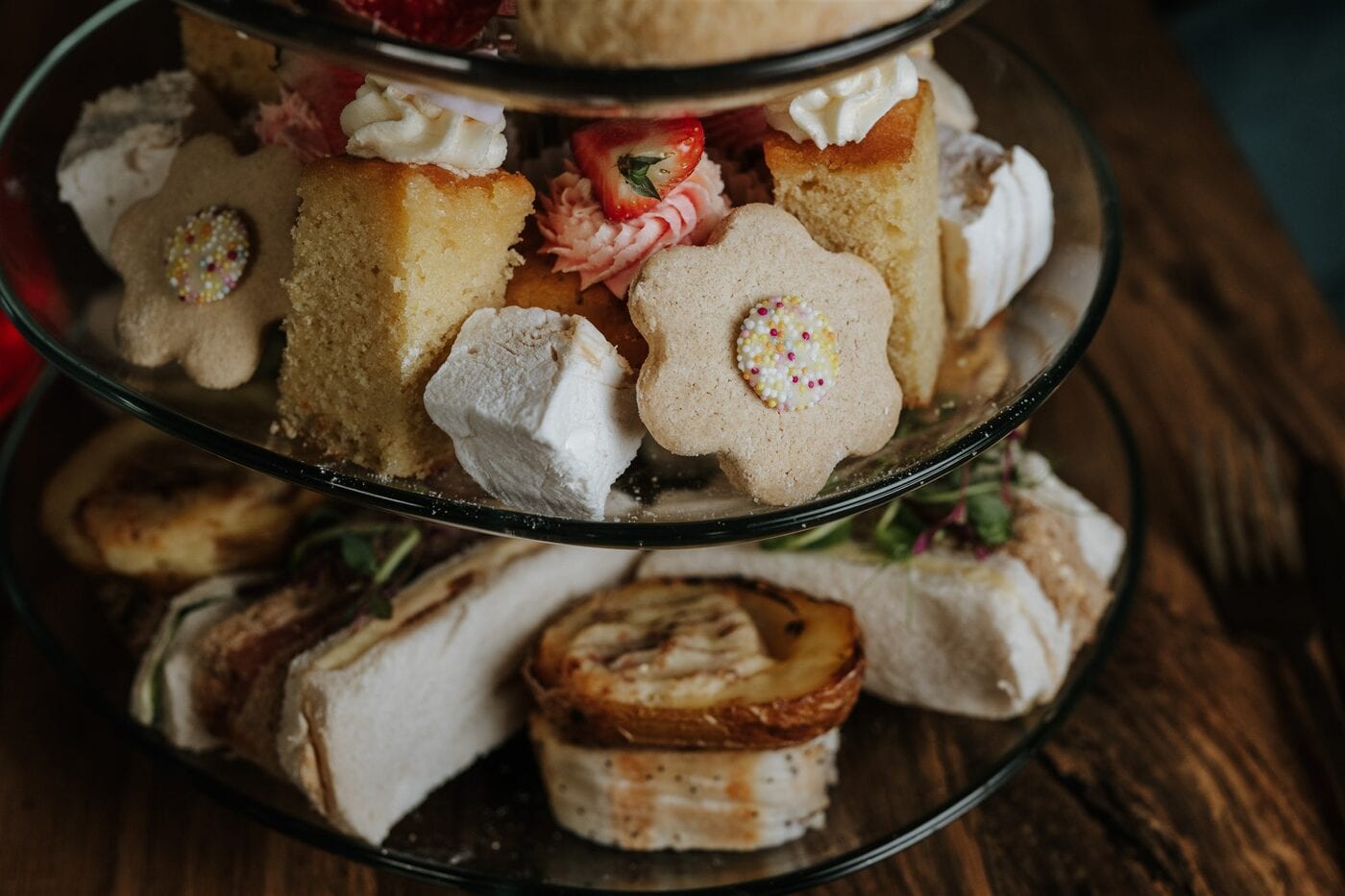 A tiered afternoon tea of scones, cakes and sweet treats at The BarnYard