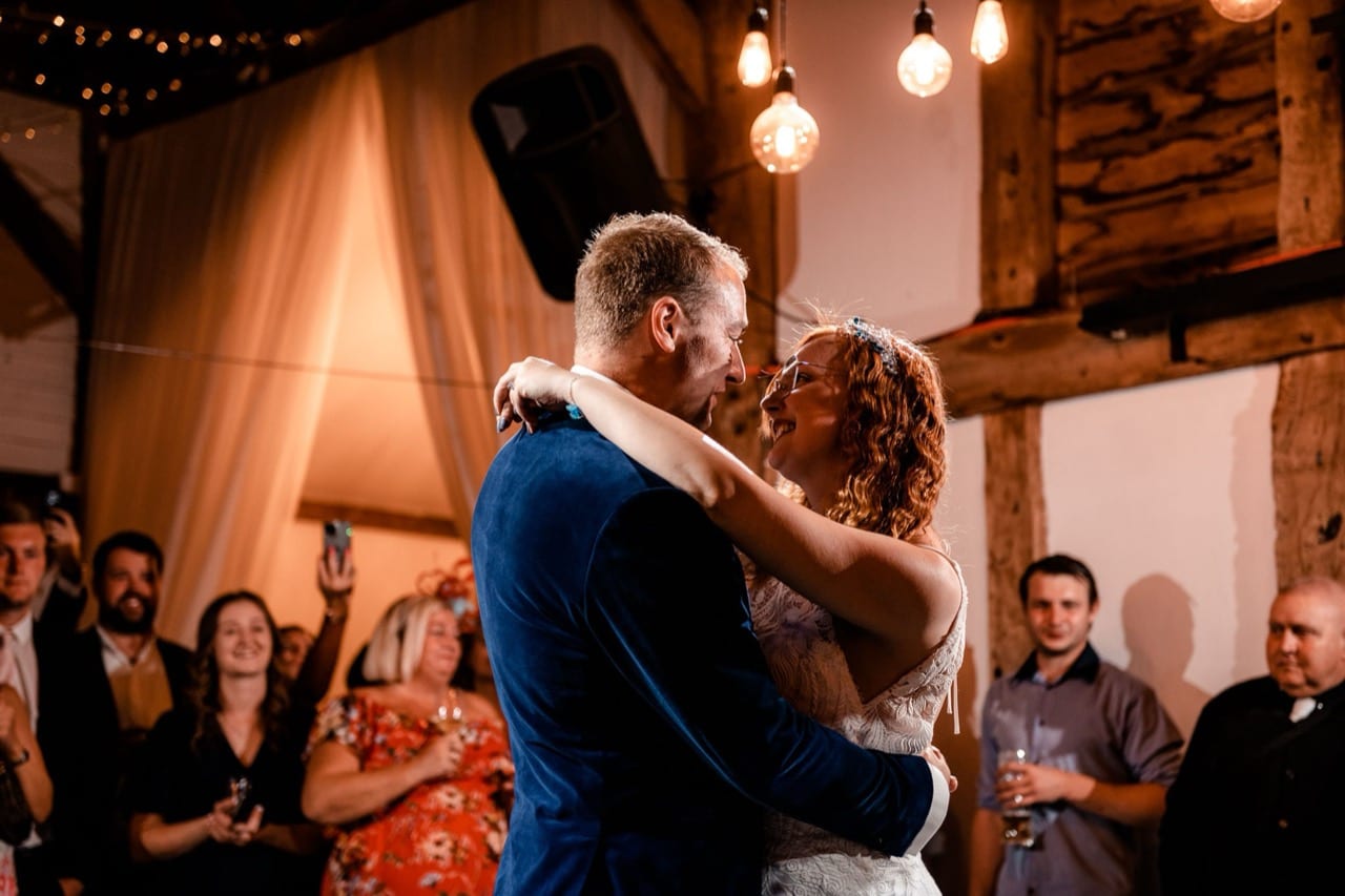 An evening party on the dance floor under festoon lights at The BarnYard