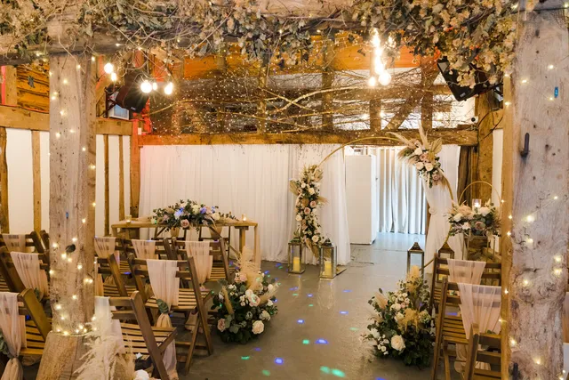 The Apple Barn dressed for a ceremony with lanterns, florals and fairy lights