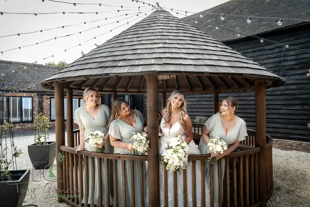 A bride and her bridesmaids on the Courtyard gazebo balcony