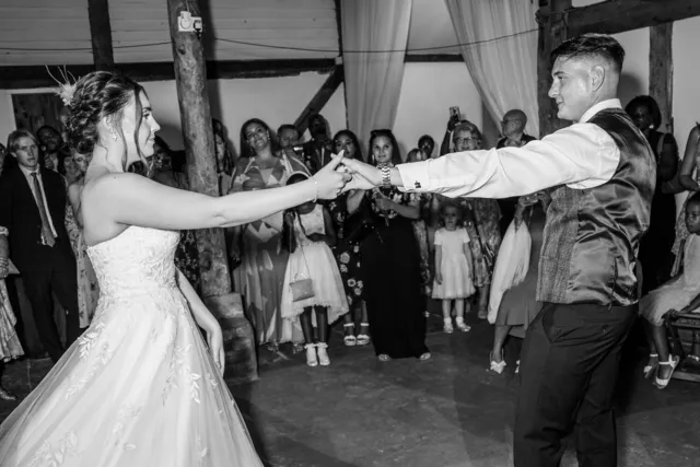 Guests raise their arms around the couple on the dancefloor