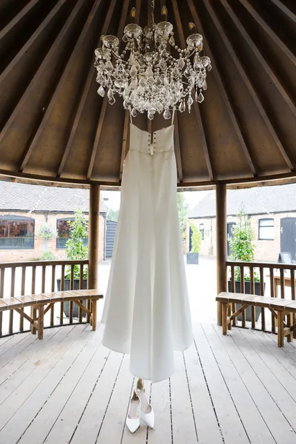A wedding dress hanging in the Courtyard gazebo