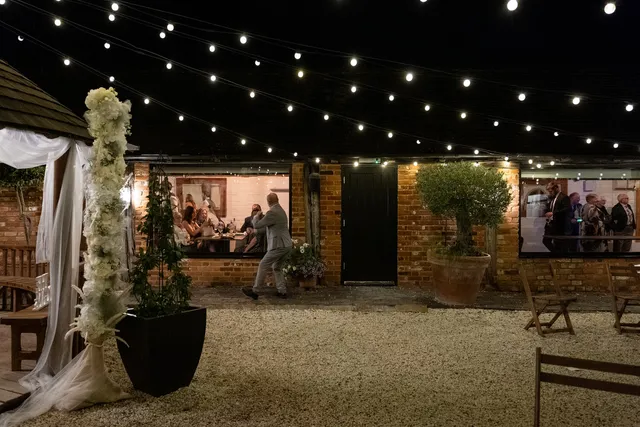 The Courtyard at night, strung with festoon lights