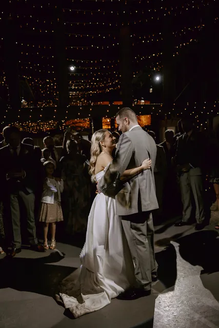 A couple's first dance surrounded by their guests