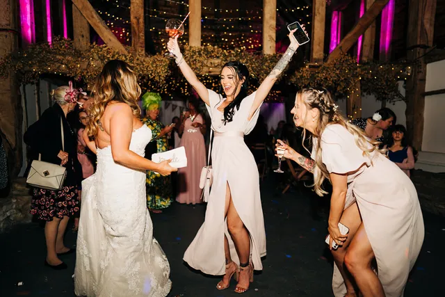 Guests celebrating with drinks on the dancefloor
