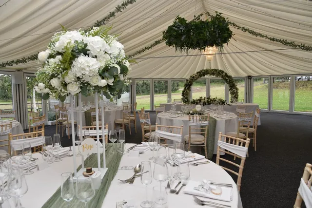 The Arboretum laid for a wedding breakfast with tall florals