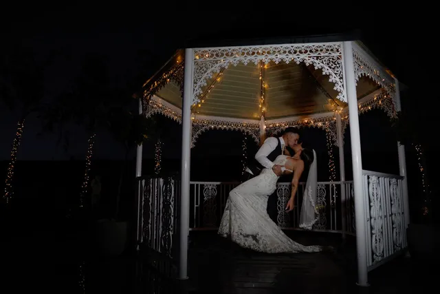 A couple dancing alone in the lit gazebo