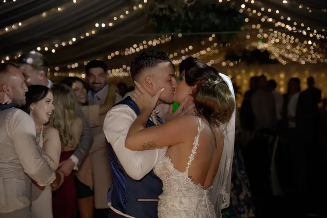 A couple kissing in the middle of the dance floor