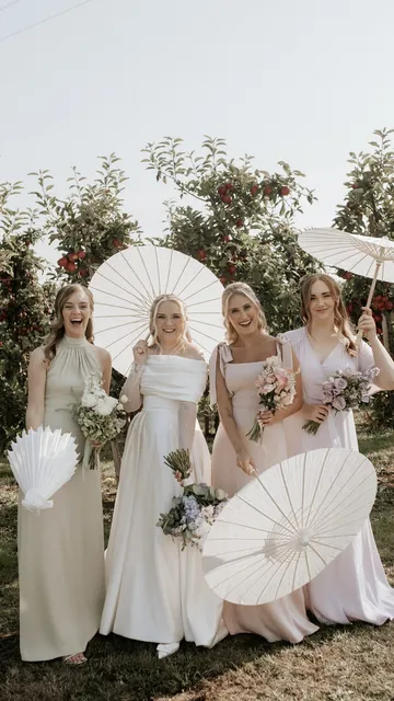 Bridesmaids with parasols in the orchards