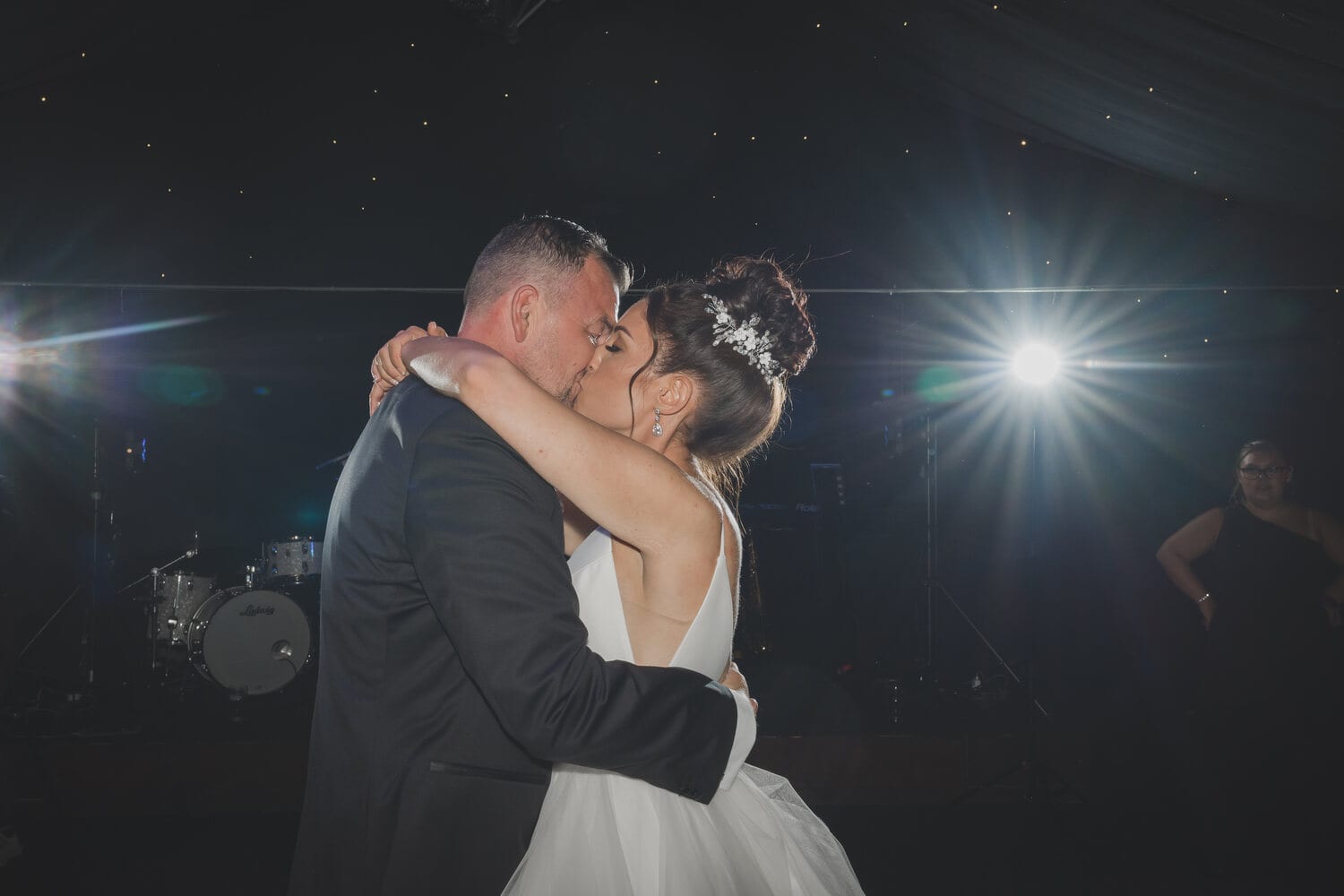 A couple share a first dance in the Arboretum