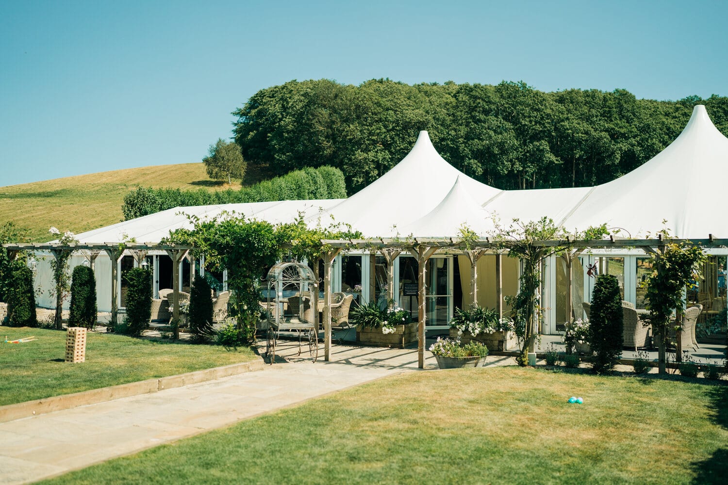 The white Arboretum marquee in the grounds by day