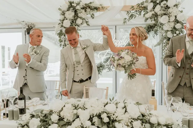 A cake table dressed with white roses