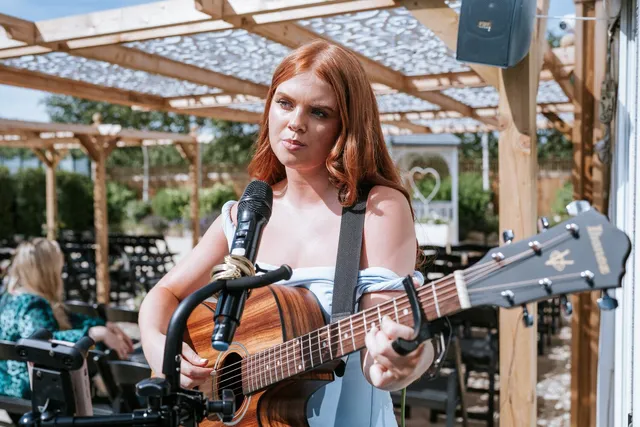 A singer performing at the Arboretum