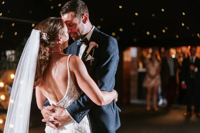 A couple dancing under the string lights