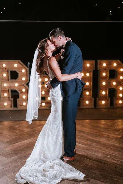 A first dance beside illuminated letters