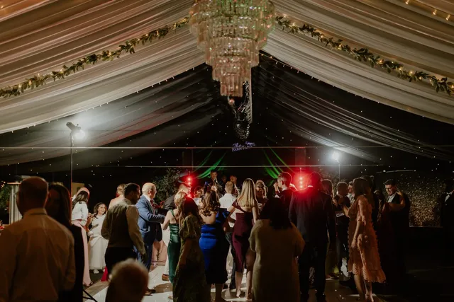 The dance floor filling up under the chandeliers