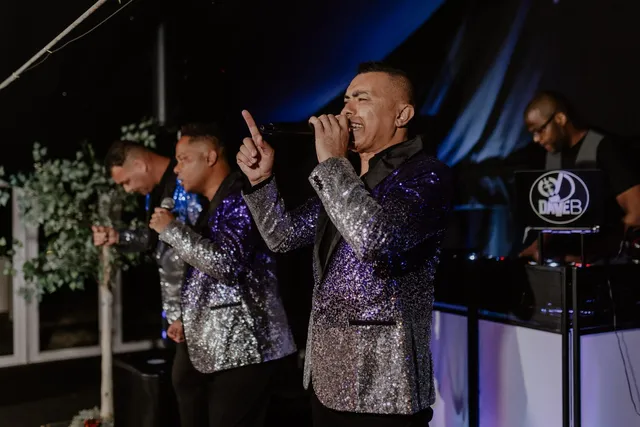 A band in sequin jackets performing