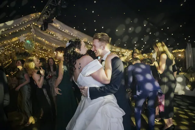 A couple dancing among their guests