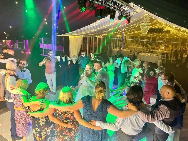 Arms around shoulders on a busy dance floor
