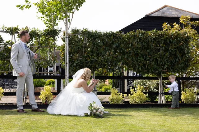 A bride and groom playing on the lawn