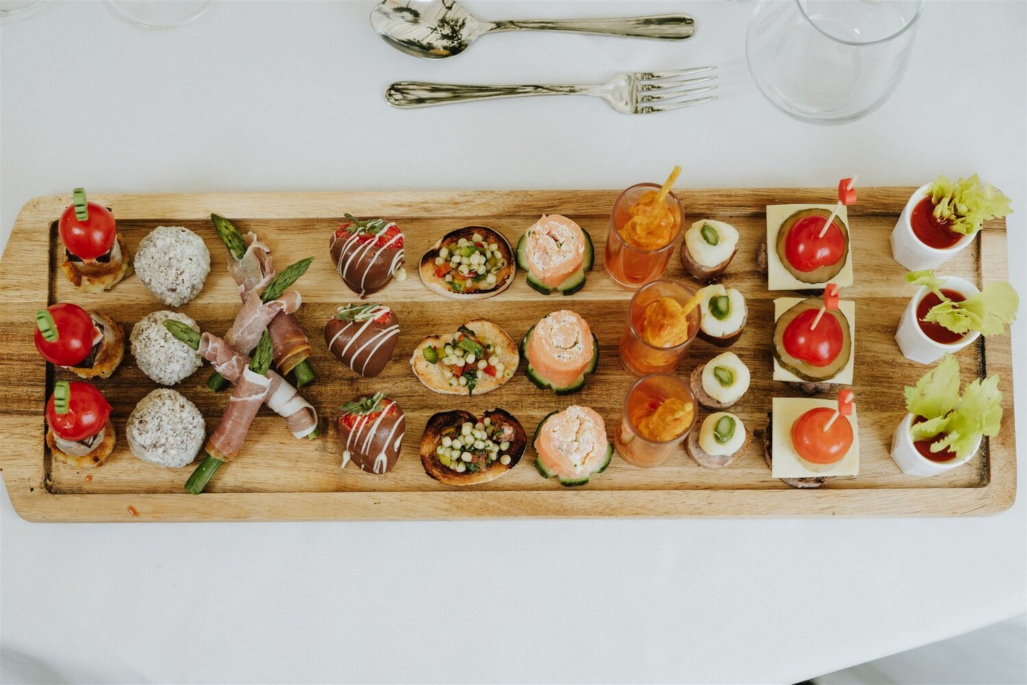 Canapés beautifully presented on a wooden board