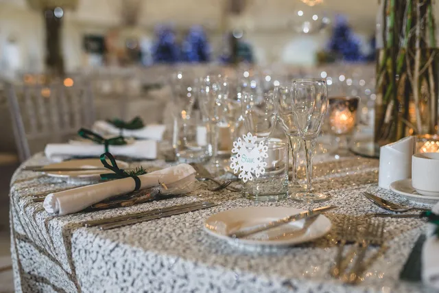 A festive table setting with snowflake details and crackers