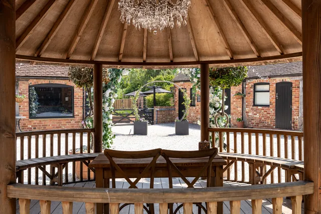 Inside the Courtyard gazebo, set for a ceremony with a chandelier above
