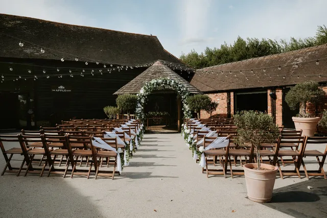 The Courtyard aisle lined with chairs and florals, the gazebo ahead