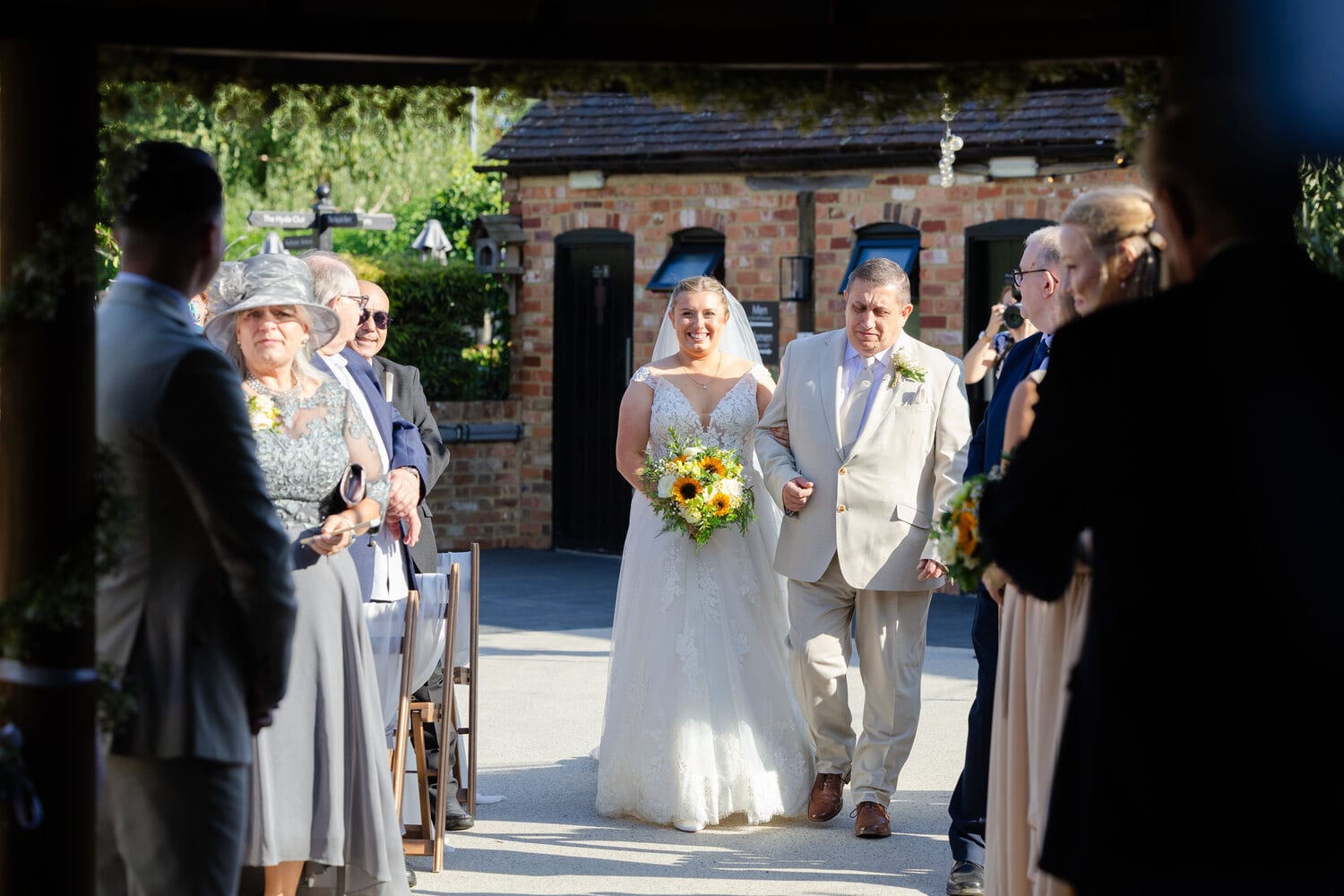 A couple walking through the courtyard after their ceremony