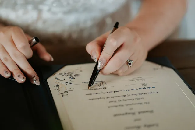 A bride signs the wedding register