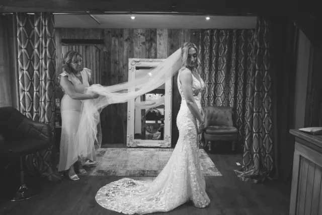 A bride's dress and veil laid out in the suite