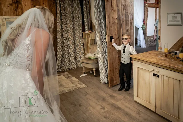A pageboy peeping round the door of the bridal suite