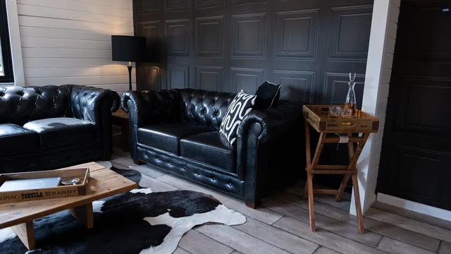 Chesterfield sofas and cowhide rugs in The Hyde Out