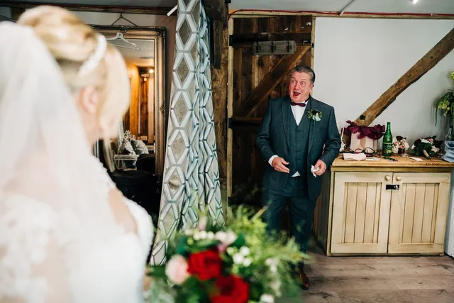 A father seeing his daughter in her dress for the first time