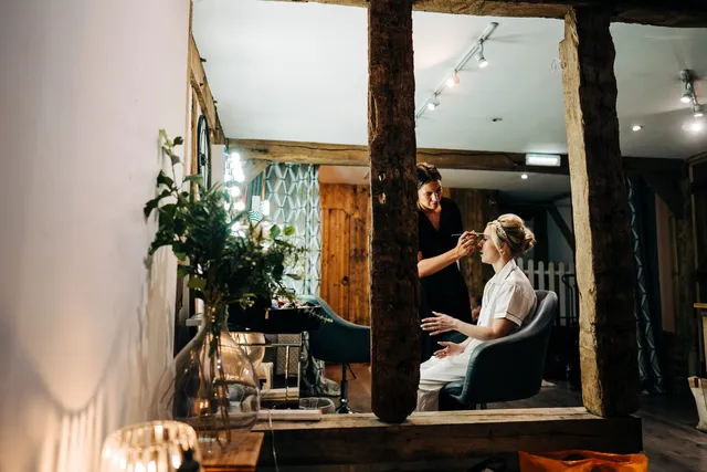 Hair and makeup underway in the mirrored suite