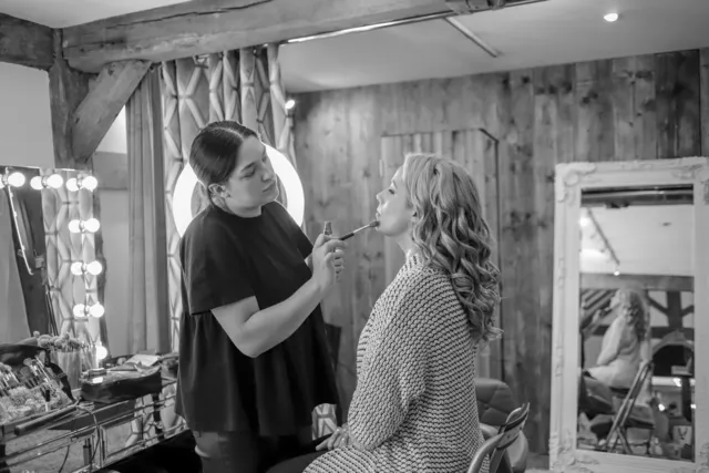 Makeup being applied at the ring light mirror