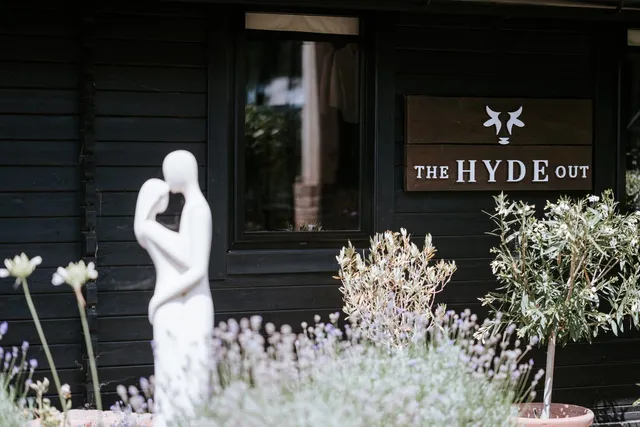 The Hyde Out sign among the lavender outside