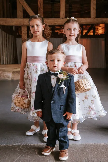 Flower girls and a pageboy ready in the barn
