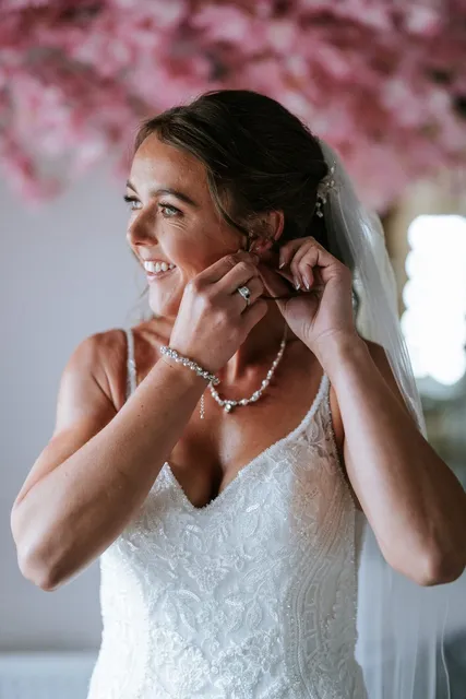 A bride fastening her earring