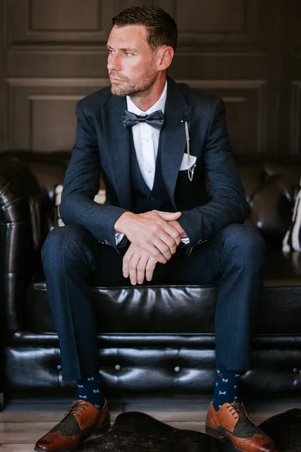 A groom in a bow tie seated in The Hyde Out