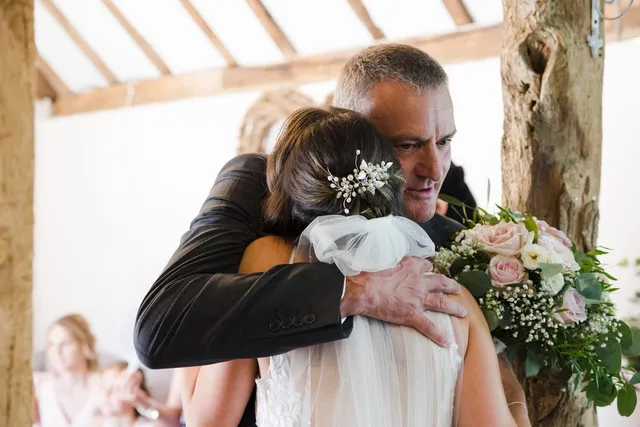 A father hugging his daughter before the ceremony