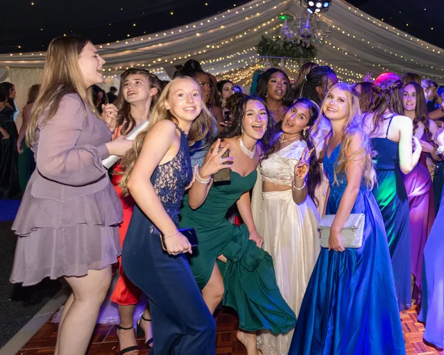 Prom guests dancing together in the barn