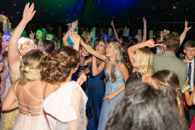 Guests with their hands in the air on the dancefloor