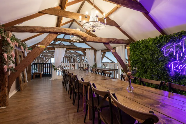 A long table set for a celebration beneath the oak beams
