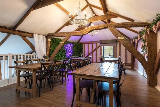 Tables set for a private party in the beamed barn