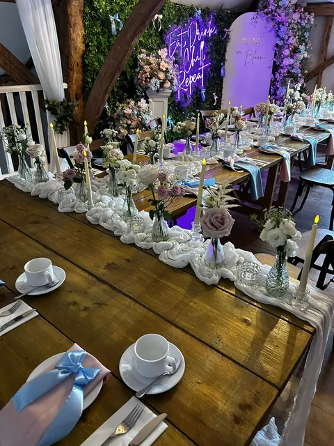 A long banquet table dressed with candles and florals