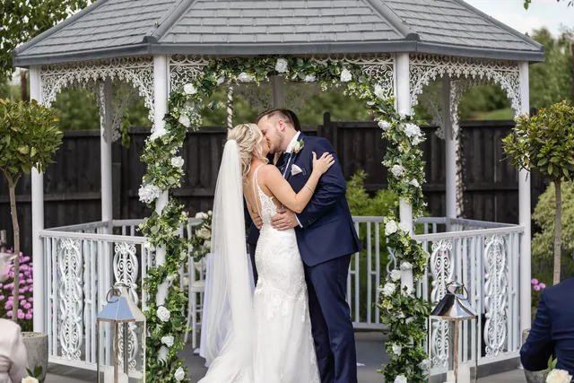 A first kiss at the floral gazebo