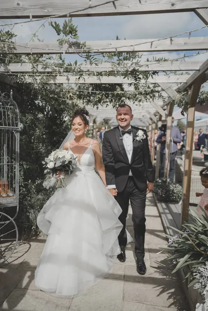 A bride and groom walking back up the aisle