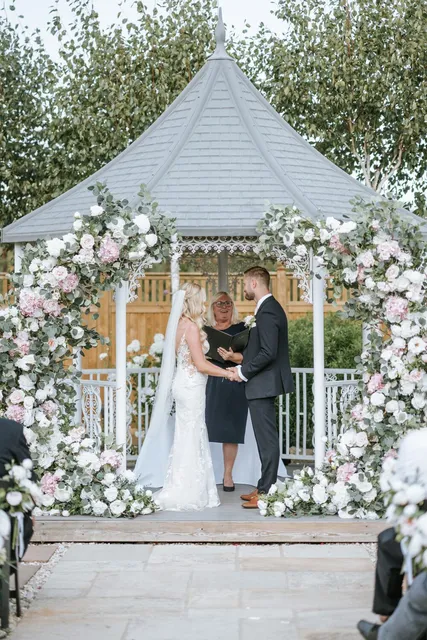 A ceremony under way at the floral gazebo